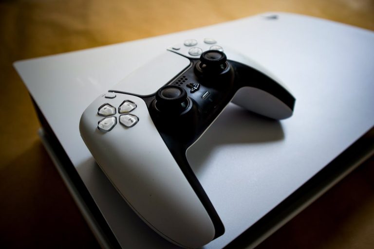 Manette PlayStation 5 posée sur une console PS5